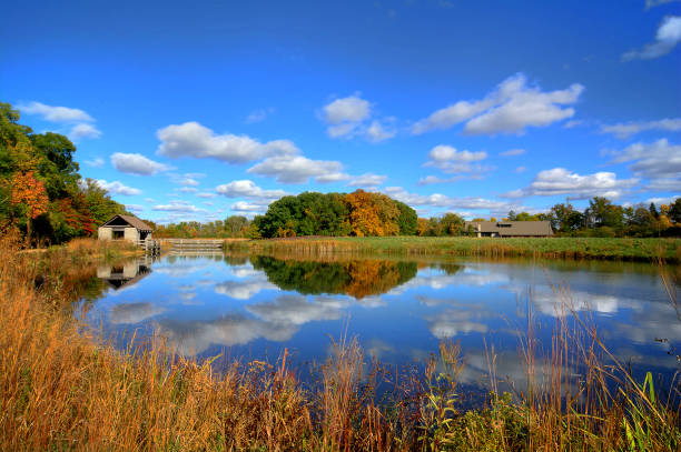 Beautiful autumn scene at a tranquil fishing pond in Ohio. The pond features a rustic shelter house. Located in the W.W. Knight Nature Preserve.