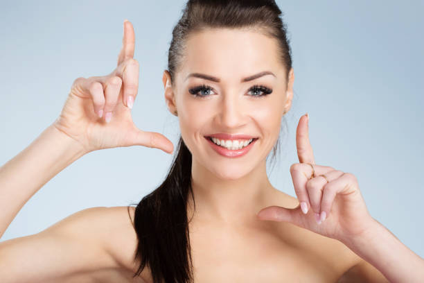 istock Young happy woman with black hair framing with hands 801965742
