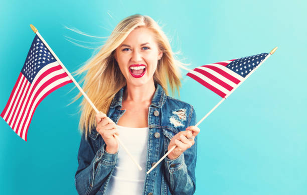 istock Young woman holding American flag 802004724