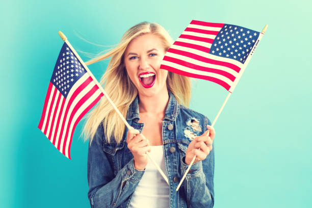 istock Young woman holding American flag 802004728