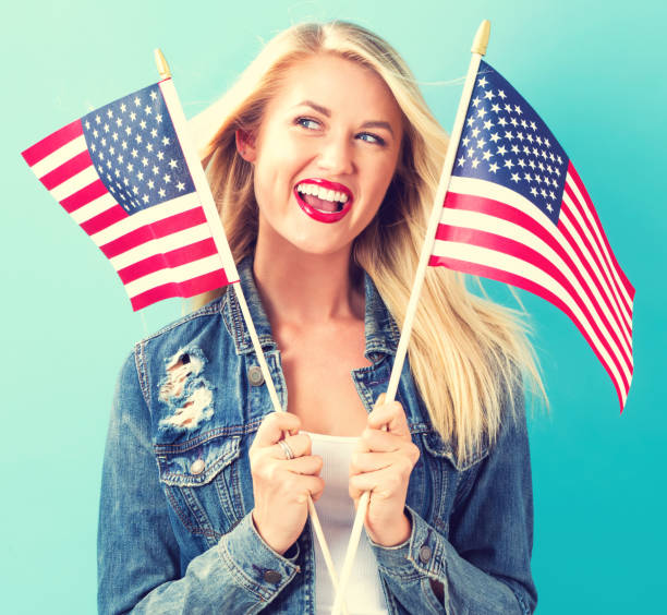 istock Young woman holding American flag 802004738