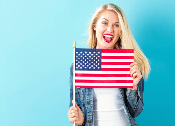 istock Young woman holding American flag 802004742