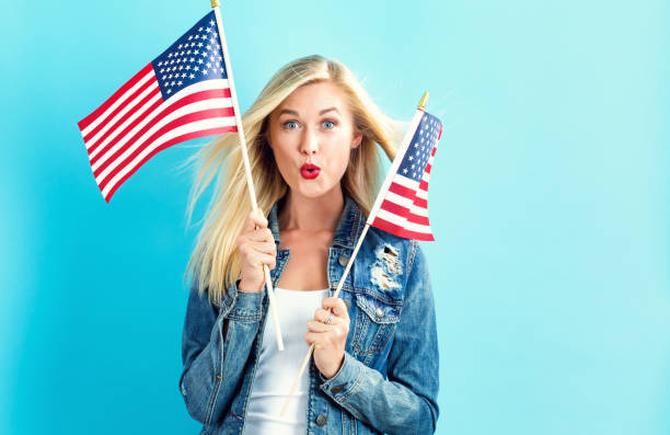 istock Young woman holding American flag 802004744