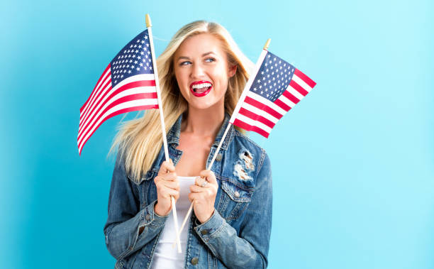 istock Young woman holding American flag 802004748