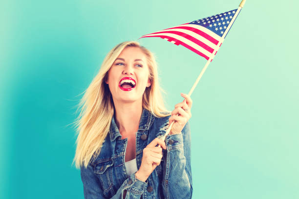 istock Young woman holding American flag 802004754