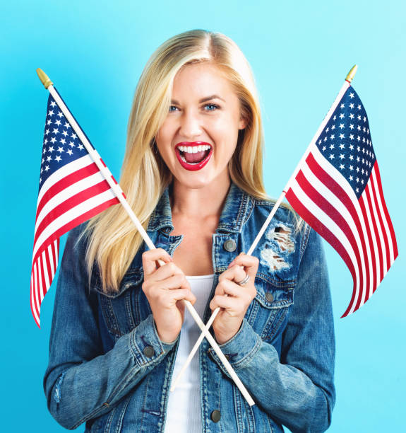 istock Young woman holding American flag 802004758
