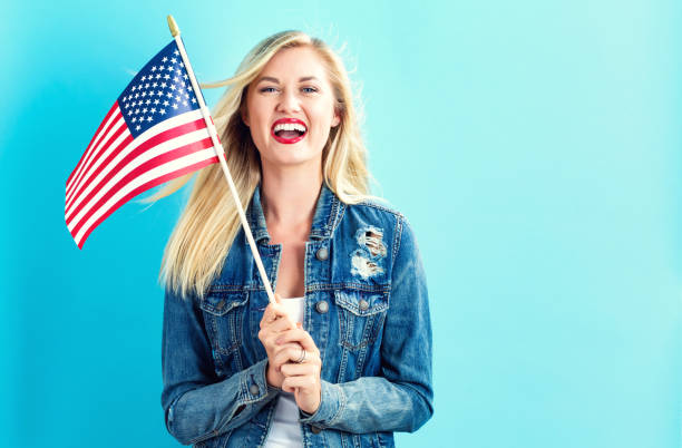istock Young woman holding American flag 802004776