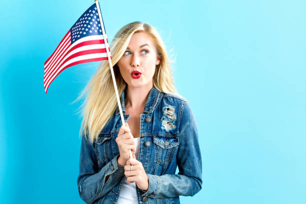 istock Young woman holding American flag 802004778
