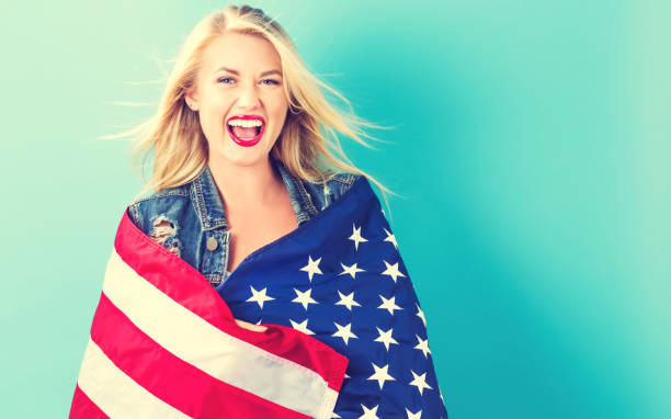 istock Young woman holding American flag 802004812