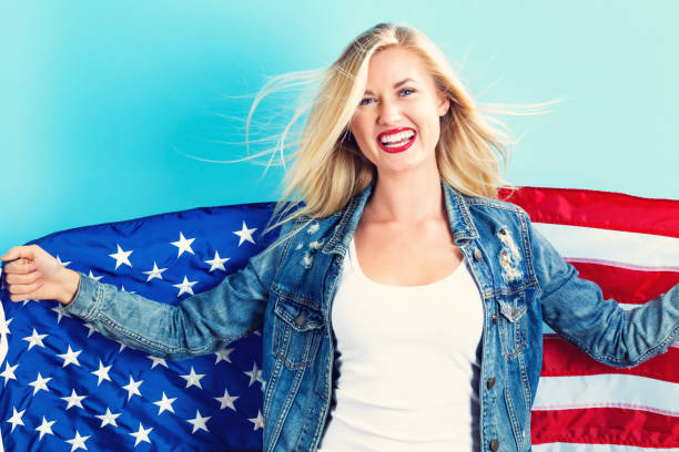 istock Young woman holding American flag 802004820