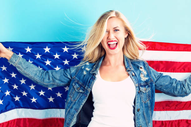 istock Young woman holding American flag 802004824