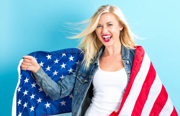 istock Young woman holding American flag 802004828