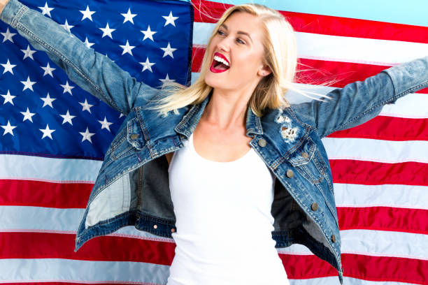 istock Young woman holding American flag 802004856