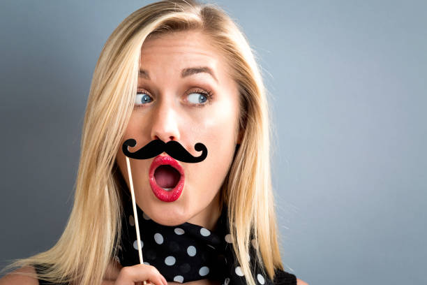 istock Young woman holding paper party sticks 802004976