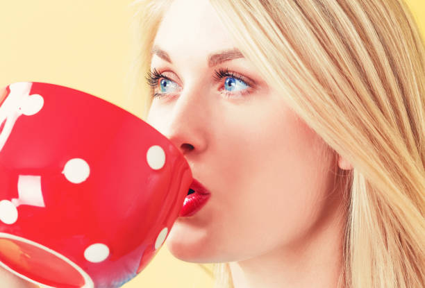 istock Happy young woman drinking coffee 802005054