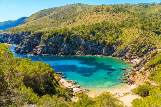 Photo of View of secluded Cala d'en Serra beach and coastal cliff rocks, Ibiza island, Spain