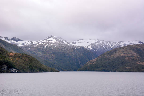 The mountains of the Alberto de Agostini National Park, Chile Beagle Channel, Alberto de Agostini National Pa, Chile - February 23, 2016: View of the mountains of the Alberto de Agostini National Park of Chile, flows down into the Beagle Channel.  favorite tourist cruise ship passage and designated a Biosphere Reserve by UNESCO. beagle channel photos stock pictures, royalty-free photos & images