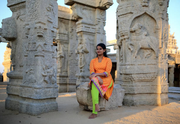 istock Beautiful Female Sitting at Lepakshi Temple 802014042