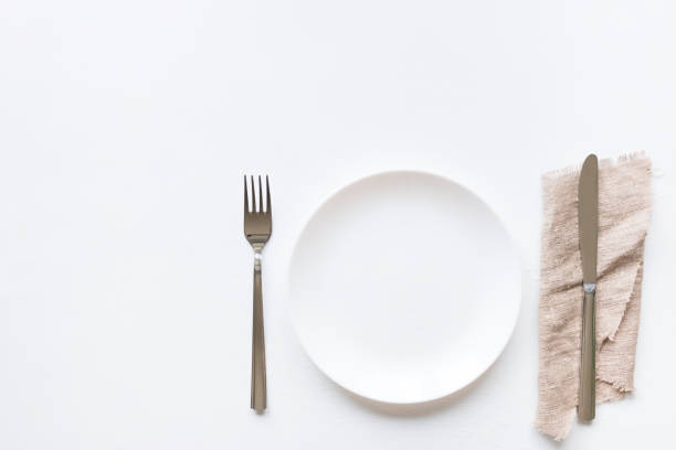 istock Empty plate on a white background and cutlery on a napkin mockup 802016316