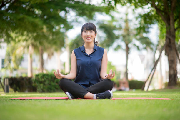 istock yoga woman on green park 802021030