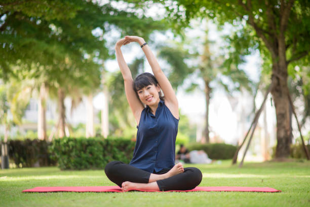 istock yoga woman on green park 802021180