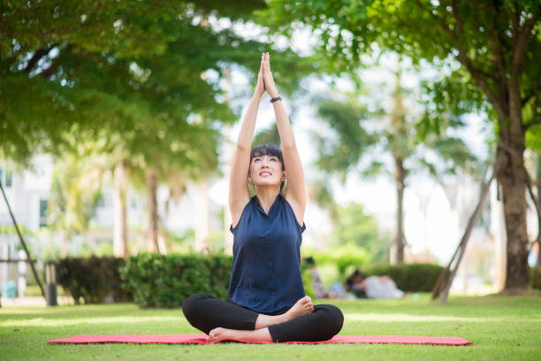 istock yoga woman on green park 802021250