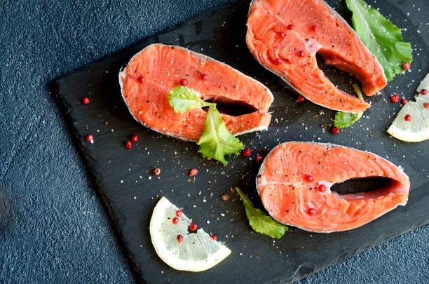 istock Salmon steaks pepper salt greens lemon 802030020