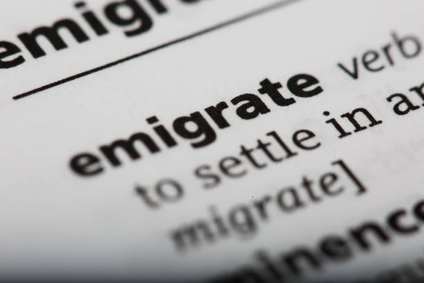 istock Word emigrate printed and defined in a English dictionary 802035414
