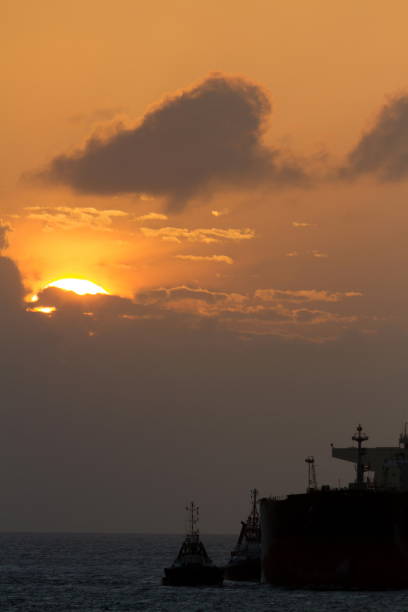 istock Tanker Ship Leaves to Sail Deep Sea at Sunset 802036164