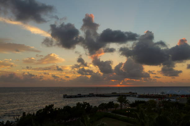 istock Sun Sets Behind Clouds at a Caribbean Beach Coast 802047756