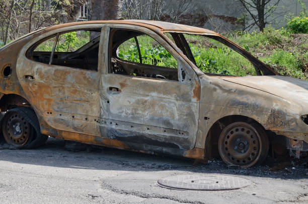 istock Burned car parked on the street side view 802048154