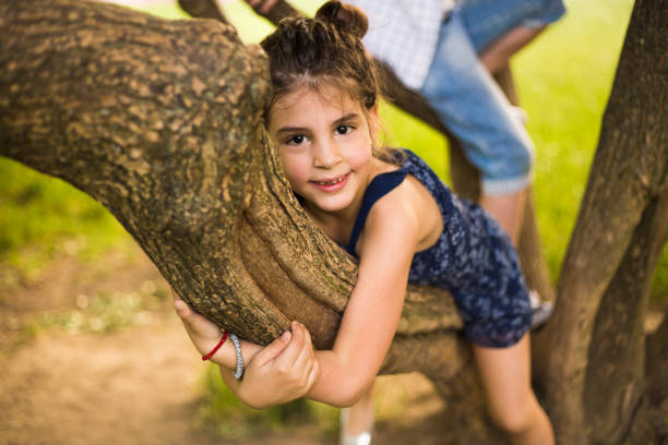 10 year old Girl smiling at the camera in the park portrait