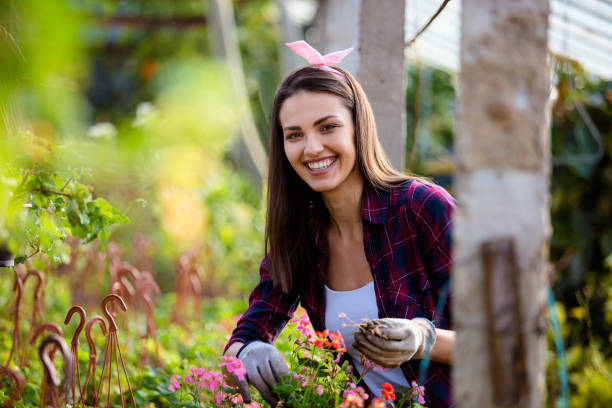 istock Happy young woman gardening 802076846