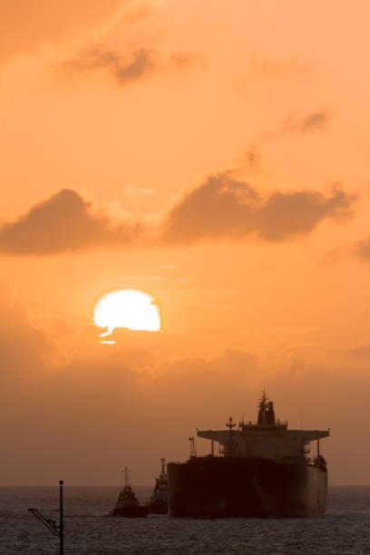 istock Tanker Ship and Tug Boats During Sunset 802105136
