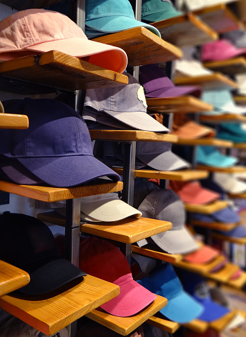 An assortment of colorful baseball caps for sale