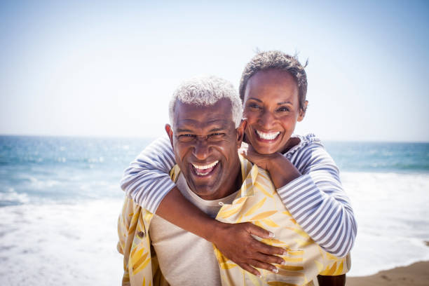 istock Black Couple Piggyback on Beach 802107544