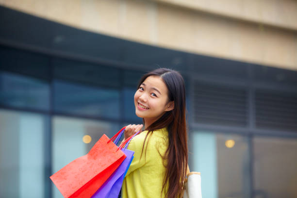 istock a beautiful young woman shopping happily 802124854