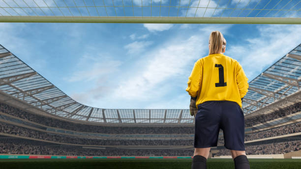 istock female goakeeper standiing on goal on crowded stadium 802126748