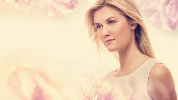istock Young woman on a pink floral background 802127548