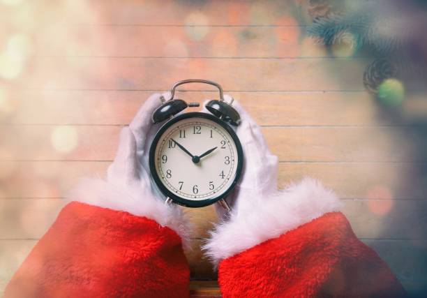 istock Santa Claus holding Chrstmas alarm clock 802133806