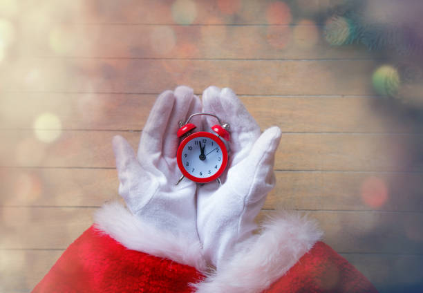 istock Santa Claus holding Chrstmas alarm clock 802133812
