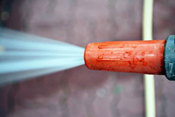 istock Water spraying from a garden hose 802153750