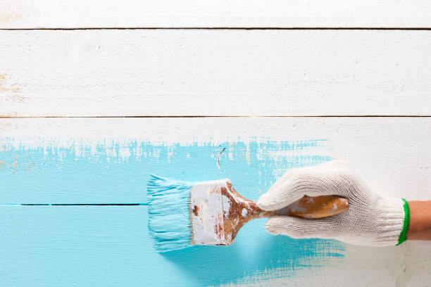 istock Hand painting blue color on wooden table. 802164288
