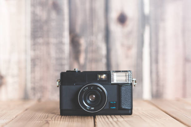 istock Old camera on the wooden table 802166292