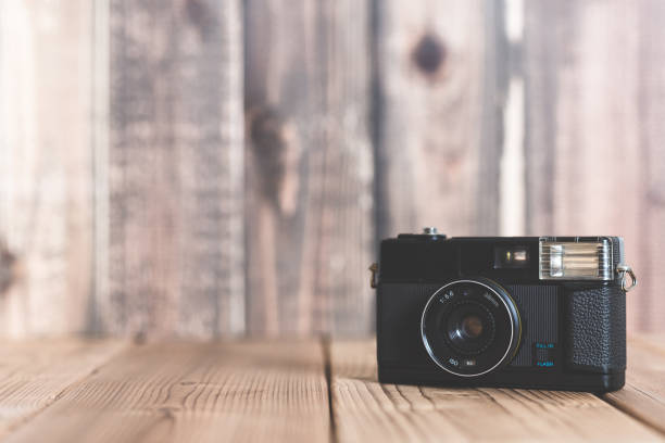 istock Old camera on the wooden table 802166312