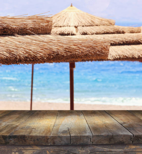 istock Empty old table in front of tropical sea and beach. Useful for product display montage 802174894