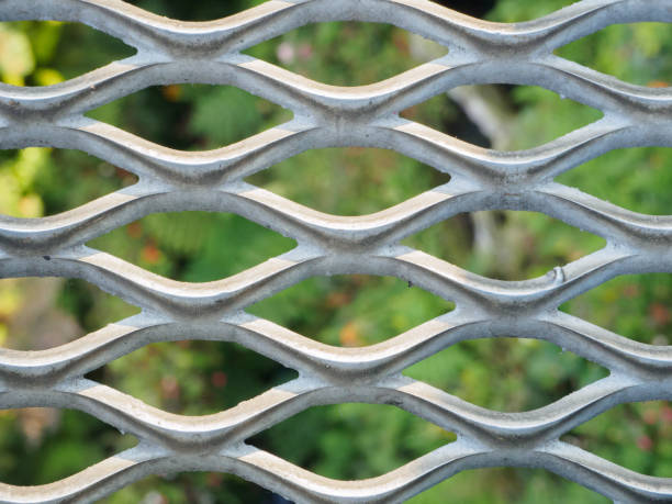 istock Metal net with green blured background. 802192930