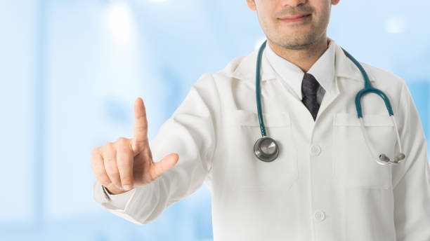istock Male doctor pointing finger at copy space. 802195628