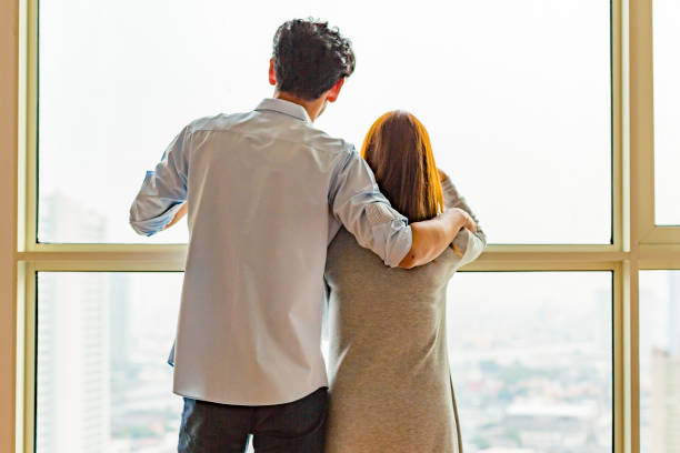 istock Asian Couple Looking Out a Window 802198436