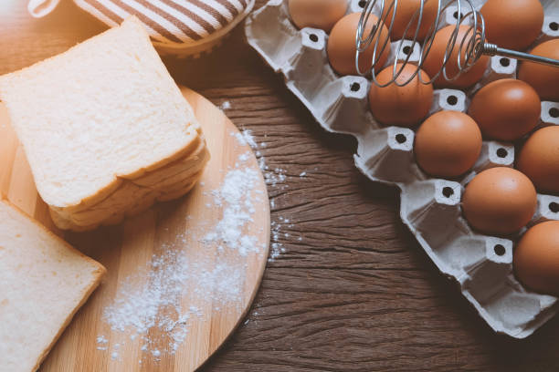 istock Bread and eggs in a tray on a wooden table 802218022